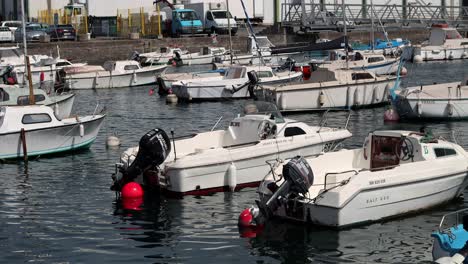 Variety-of-small-boats-moored-to-buoys-float-peacefully-in-Brest,-France-harbor