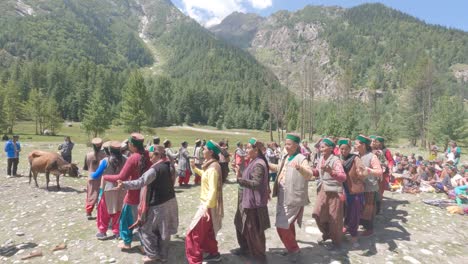 A-group-of-Indian-Himachali-Kinnauri-women-singing-folk-songs-and-celebrating-festival-Pori-on-meadows-surrounded-by-the-Himalayan-mountain-range