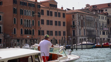 Water-Taxi-Driver-On-Grand-Canal-In-Venice,-Italy---POV