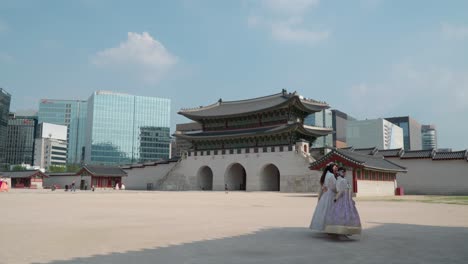 Young-Girls-In-Traditional-Hanbok-Clothing-Taking-Pictures-At-Popular-Gyeongbokgung-Palace-With-Gwanghwamun-Gate-In-The-Background