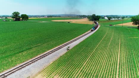 Thomas-the-Train-Steam-Locomotive-in-Amish-Countryside-on-a-Sunny-Summer-Day-as-seen-by-a-Drone