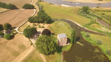 A-tiny-farm-building-situated-right-beside-a-small-inlet-of-water-surrounding-the-local-area