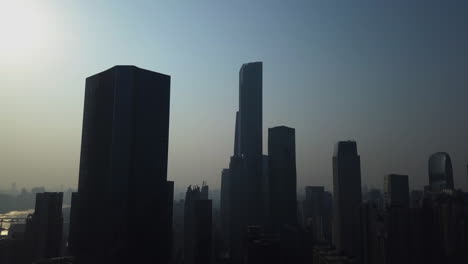 Aerial-shot-of-mega-city-Guangzhou-Central-building-district-with-skyscrapers-on-a-sunny-day-in-the-afternoon