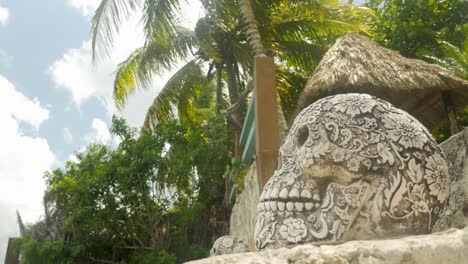 Mexican-sculpted-skulls-on-stairs-in-tropical-place