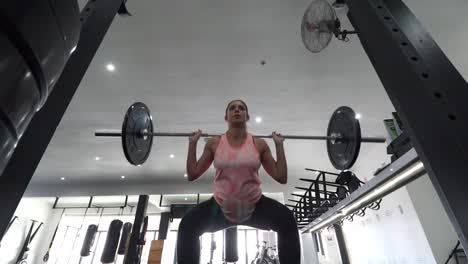 Footage-of-a-pregnant-female-model-doing-squats-in-a-gym-trying-to-keep-fit-in-her-fourth-trimester