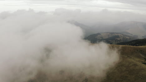 Aerial-shot-of-Flying-towards-white-cloud-over-autumn-mountain,-Slovakia
