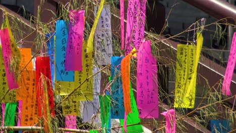 Close-up,-People-bunding-wishes-on-paper-to-a-tree-in-Zozo-ji-Temple