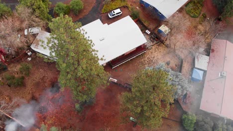 Aerial-view-of-roof-tops-and-smoke-in-a-rural-mountain-neighborhood