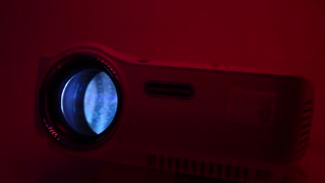 Close-Up-of-LED-Projector-Bright-Light-and-Romantic-Red-Background-Lighting