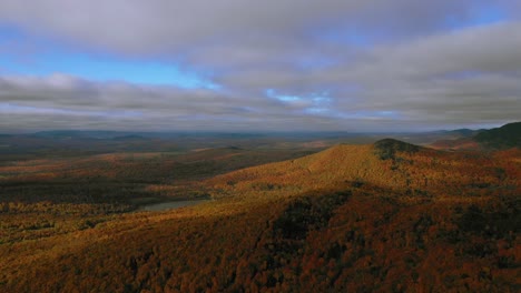 Aerial-pan-high-over-evergreen-ridge-in-a-golden-autumn-forest