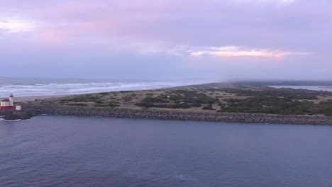 Drone-aerial-of-the-Coquille-river-lighthouse-in-Bandon-during-evening-hours-with-moody-light