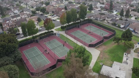 Aerial-View-of-four-tennis-courts-in-residential-neighborhood