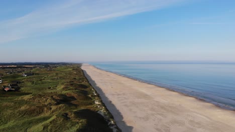 Aerial-view-of-the-North-Sea-shoreline-outside-Løkken,-Denmark,-with-white-sand-beach