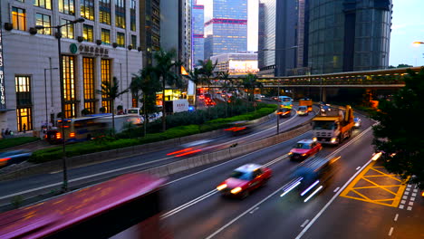 Hong-kong---Circa-Time-lapse-of-Hong-Kong-auto-and-bus-traffic-race-between-building-in-the-urban-landscape-Concept,-urban,-traffic,-rat-race,-rush,-city-life