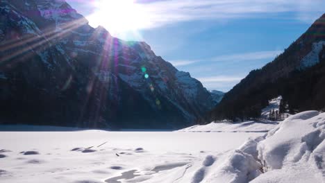 Wonderful-time-lapse-or-hyper-lapse-shot-of-a-valley-in-Switzerland-with-a-frozen-lake-while-the-sun-is-setting