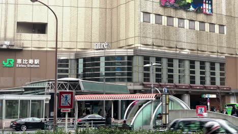 Panoramic-of-West-entrance-exit-of-Ebisu-Station-with-people-and-cars