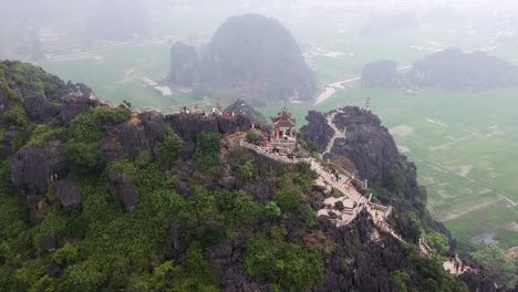 Aerial-of-Hang-Mua-temple,-limestone-karsts-and-Vietnamese-countryside,-Tam-Coc,-Ninh-Binh,-Cambodia