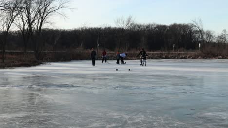A-following-action-shot-of-friends-playing-pond-hockey