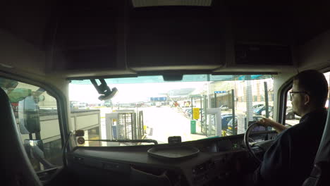 HGV-Driver-navigating-around-the-Port-Of-Dover,-UK-through-a-security-gate-into-the-container-terminal