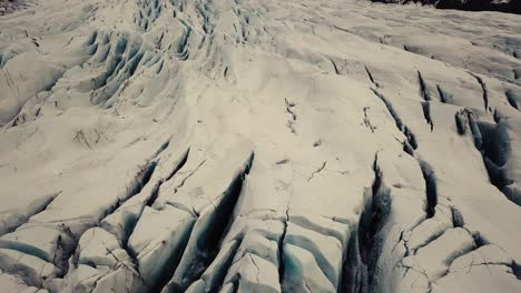 Glacier-tongue-in-Iceland-filmed-by-drone-with-different-cinematic-movements,-showing-a-cloudy,-dramatic-concept-in-wintery-conditions