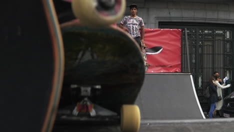 Young-skater-male-performs-the-Nose-Stall-trick-on-a-ramp