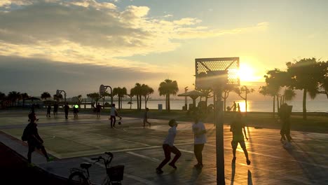 Teenagers-Playing-Basketball-on-Ocean-Side-court