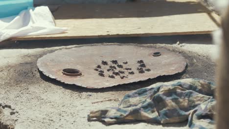 Self-built-Tandoor-oven-in-Refugee-camp-covered-with-rusty-metal-barrel-lid