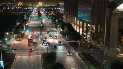 Singapore---Circa-Zooming-out-time-lapse-of-traffic-at-a-busy-intersection-at-night