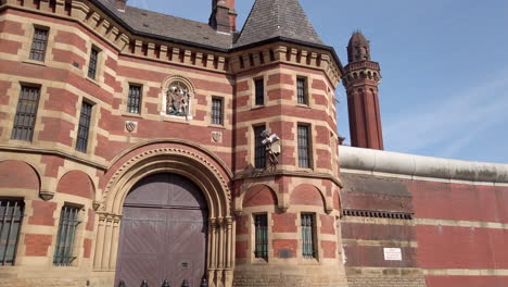 Tilt-Reveal-Shot-of-Original-Entrance-at-HM-Prison-Manchester,-England-a-High-Security-Prison-also-known-as-Strangeways-on-Sunny-Day