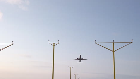 Narrow-Static-Shot-of-Airplane-Departing-from-Leeds-Bradford-International-Airport-in-Yorkshire-on-Beautiful-Summer’s-Morning-with-Approach-Lighting-System-in-Foreground