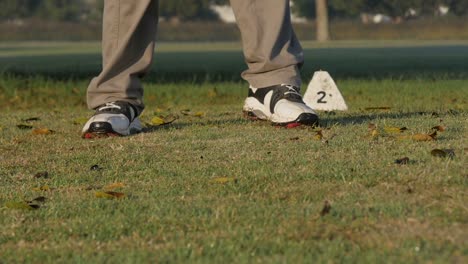 Close-up-of-a-weekend-golfer-teeing-off-from-the-second-hole,-slow-motion-and-close-up