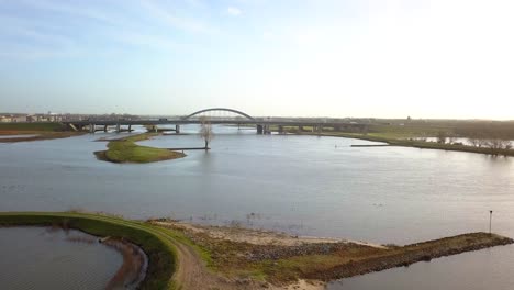 Drone-footage-over-the-river-facing-the-big-bridge-and-highway-in-4K-and-30-FPS