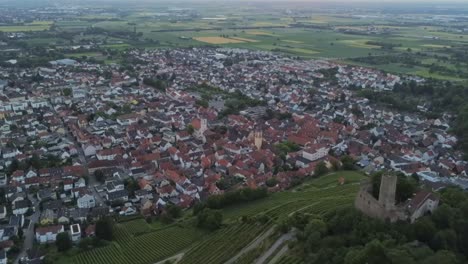 Zoom-out-aerial-view-of-Strahlenburg-castle-and-grape-vine-fields-in-the-German-city-of-Schriesheim-during-a-beautiful-sunset