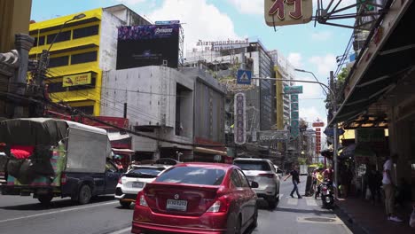 Traffic-on-busy-street-in-china-town-of-Bangkok-city-under-blue-sky,-Thailand