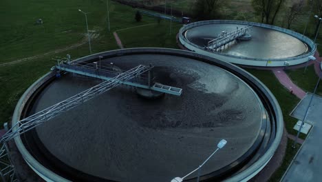 Aerial-view-of-sewage-treatment-plant,-camera-closing-up-to-the-sewage-container