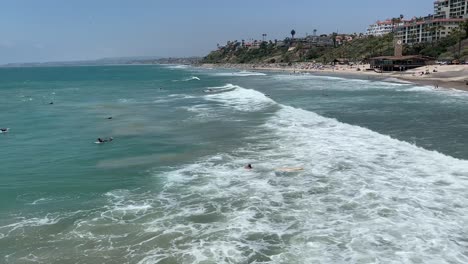 People-leisurely-surfing-and-enjoying-the-summer-sun-at-San-Clemente-Beach-in-Southern-California