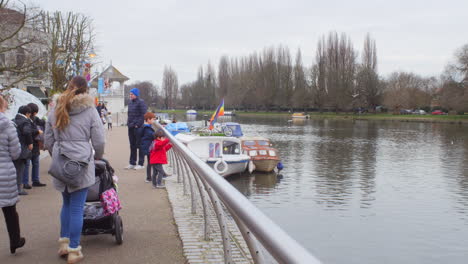 English-pedestrians-on-a-cold-and-overcast-day-near-a-river
