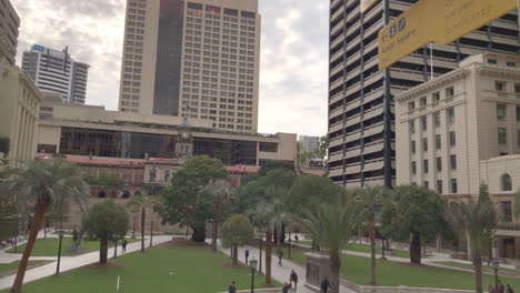 Anzac-Square-Brisbane-City,-multi-direction-signage,-people-walking