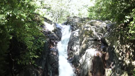 Slow-Motion-Shot-of-someone-sliding-down-the-natural-waterslide-at-AlingAling-Waterfall-in-Bali,-Indonesia