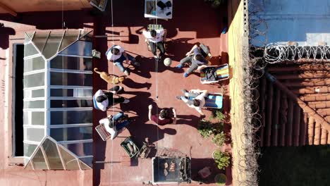 Aerial-view-of-rooftop-in-the-city-of-Montevideo-Uruguay-with-people-and-friends-having-a-barbecue-and-playing-football-on-a-sunny-day