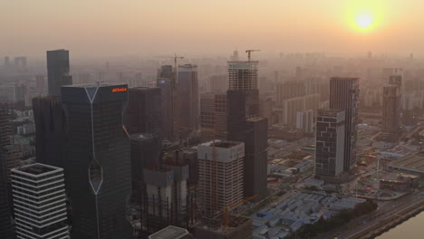 Fly-over-Alibaba-Group-Guangzhou-headquarters-construction-site-at-epic-golden-sunset