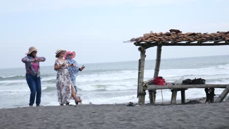 Yogyakarta,-Indonesia---Feb-21,-2021-:-Three-middle-aged-women-are-dancing-on-the-beach