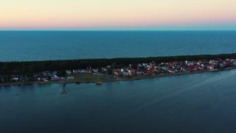 Aerial-view-of-a-beautiful-beach-with-white-sand-in-Chalupy-village,-Baltic-Sea,-Poland,-drone-sideement-along-the-shore