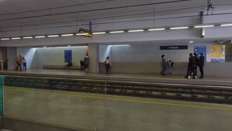 Metro-patrons-social-distance-on-the-Trindade-platform-while-waiting-for-the-train-to-arrive,-Porto-Portugal