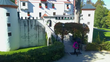 Couple-Walking-Across-Bridge-Exploring-Grad-Sneznik-Castle