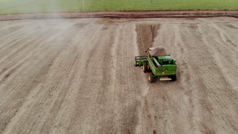 Agricultural-tractor-harvesting-soybeans-in-the-field