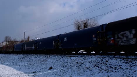 Austria-commercial-train-OBB-passing-through-the-valley-with-houses-in-the-background