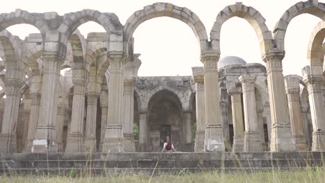 Woman-doing-Meditation-at-Unesco-world-heritage-kamani-masjid-also-called-as-kamani-mosque,-Champaner,-Gujarat