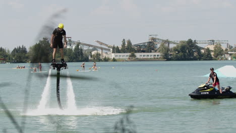 Man-In-Wetsuit-On-Flyboard-Fly-In-Lake-on-Air-Jet-Or-Water-Pressure-Force