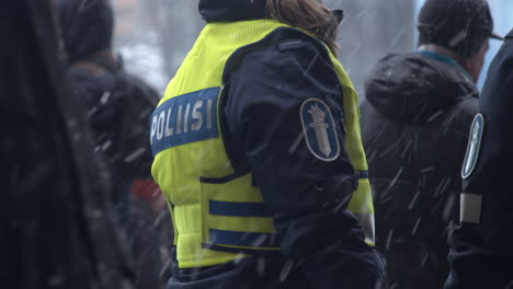 Close-up-shot-of-a-police-officers-high-visibility-vest-at-the-covid-19-demonstration-in-Helsinki,-cold-day